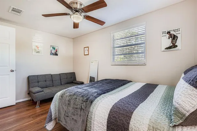 a bedroom with a bed and a couch