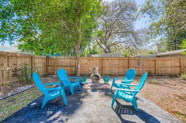 a view of a backyard with furniture and garden