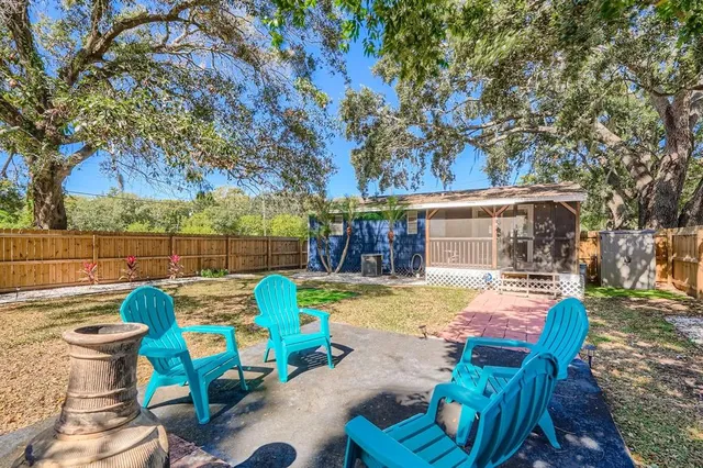 a view of a chairs and table in backyard