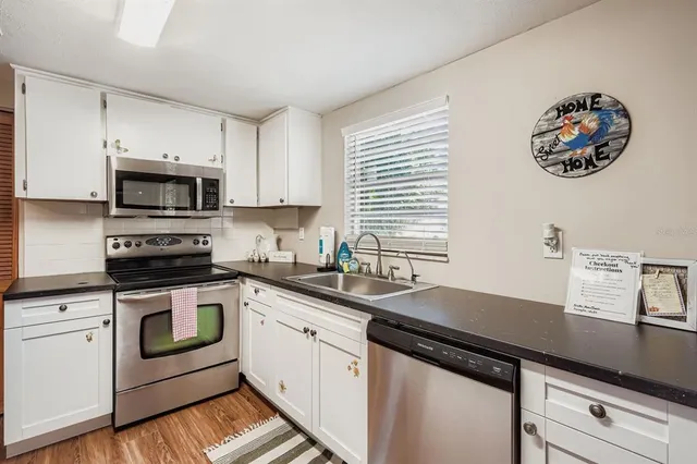 a kitchen with a sink and a stove top oven