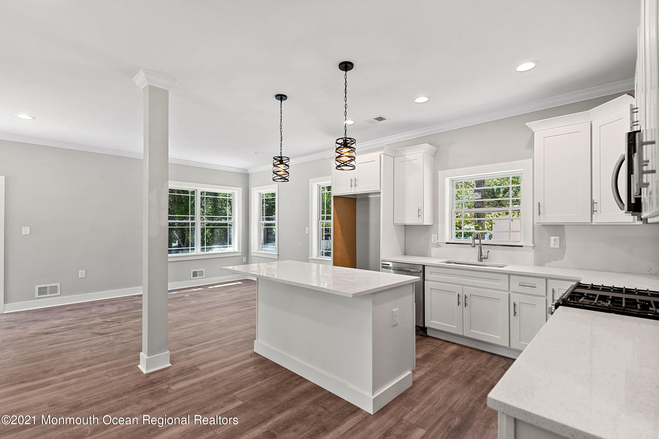 308 Riverside Drive Bayville, NJ 08721 - Photo 12 of 35 a large kitchen with stainless steel appliances granite countertop a sink a stove a refrigerator and white cabinets with wooden floor