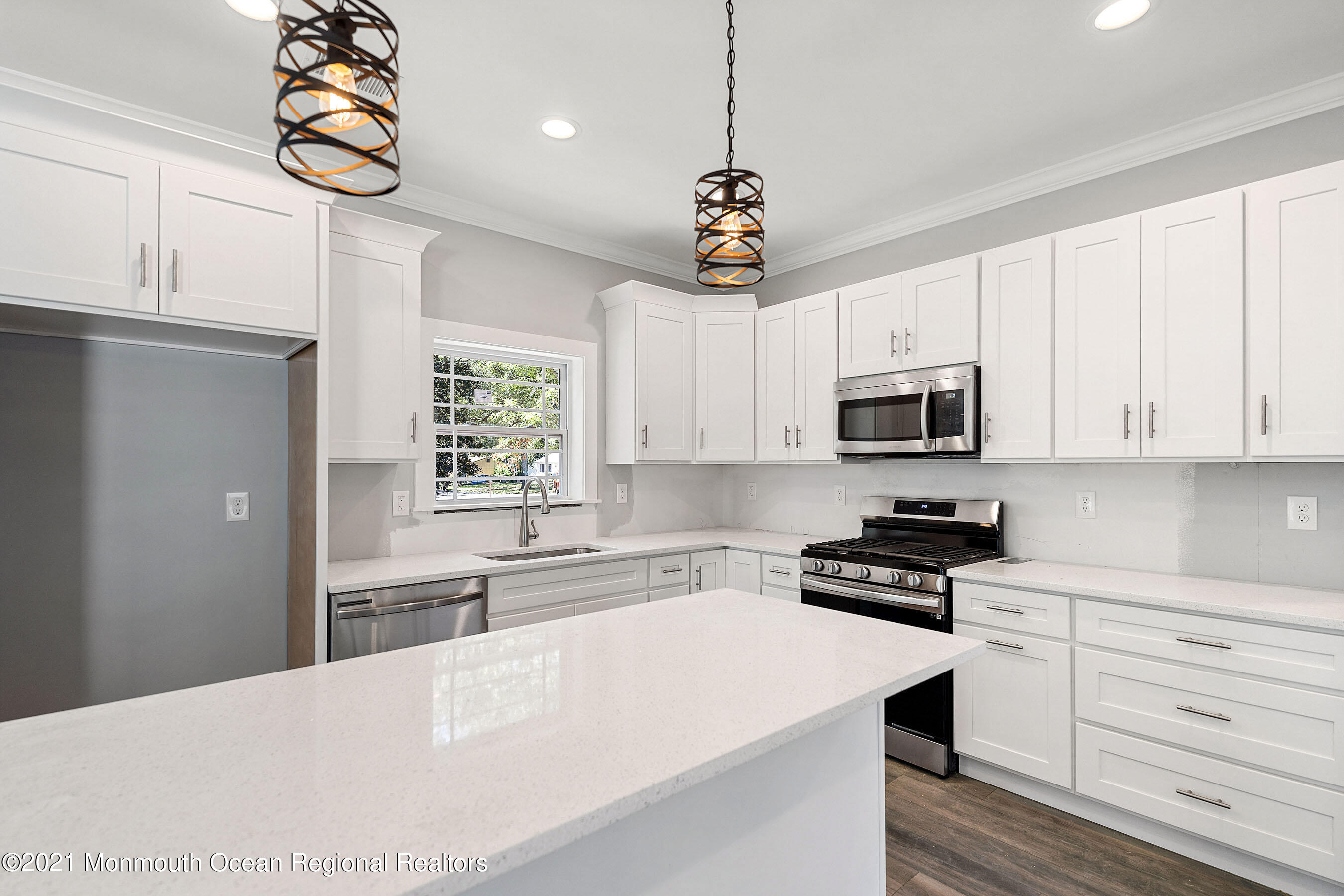308 Riverside Drive Bayville, NJ 08721 - Photo 17 of 35 a kitchen with stainless steel appliances a white center island and cabinets