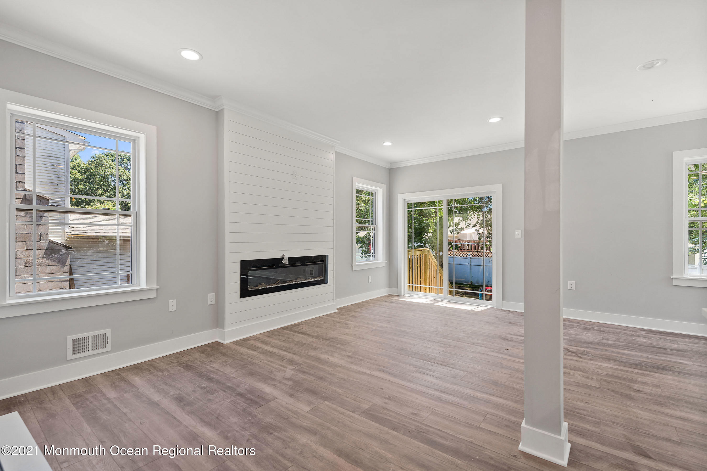 308 Riverside Drive Bayville, NJ 08721 - Photo 18 of 35 an empty room with windows and a fireplace