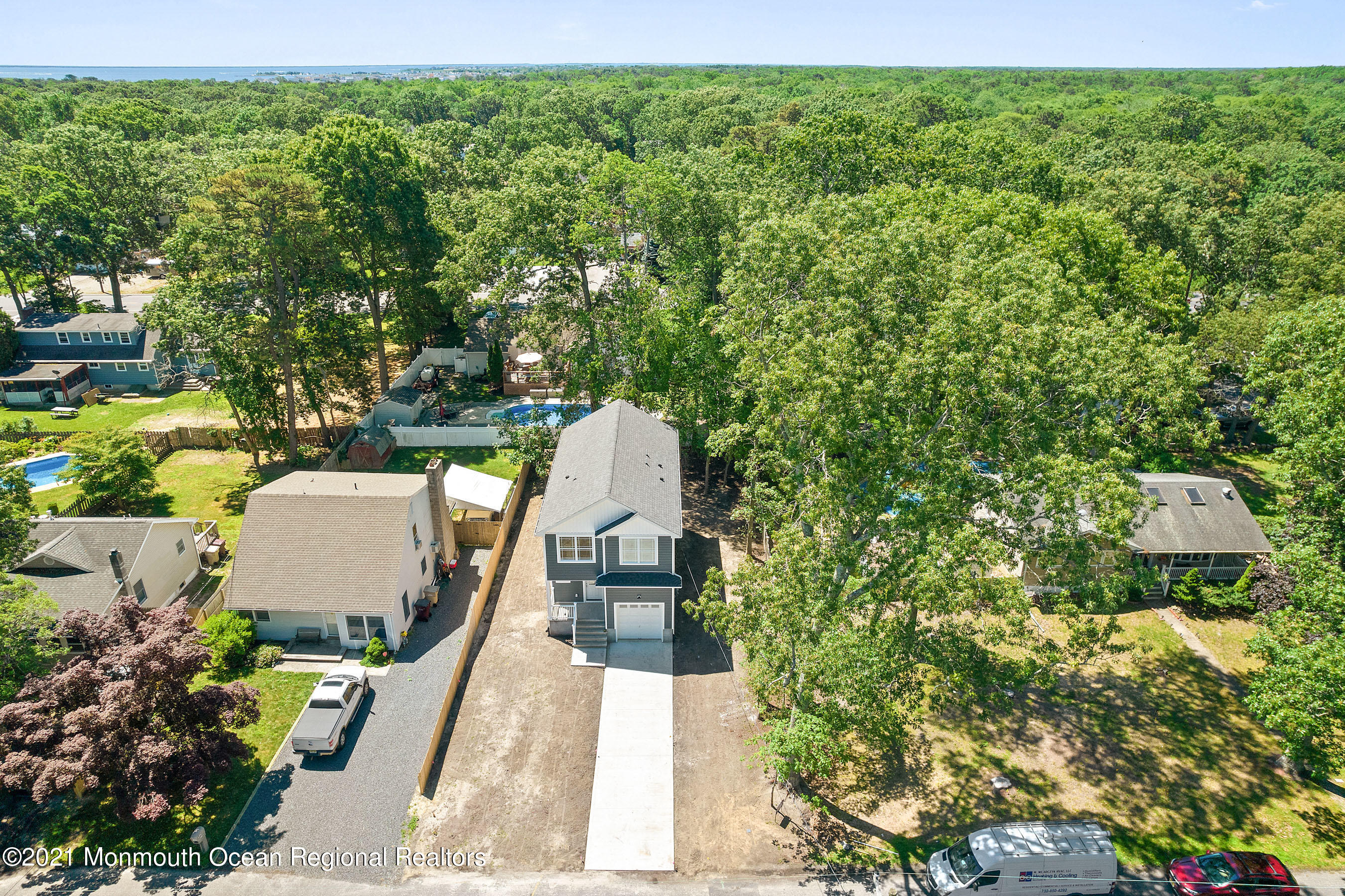 308 Riverside Drive Bayville, NJ 08721 - Photo 3 of 35 a picture of a yard with table and chairs and potted plants