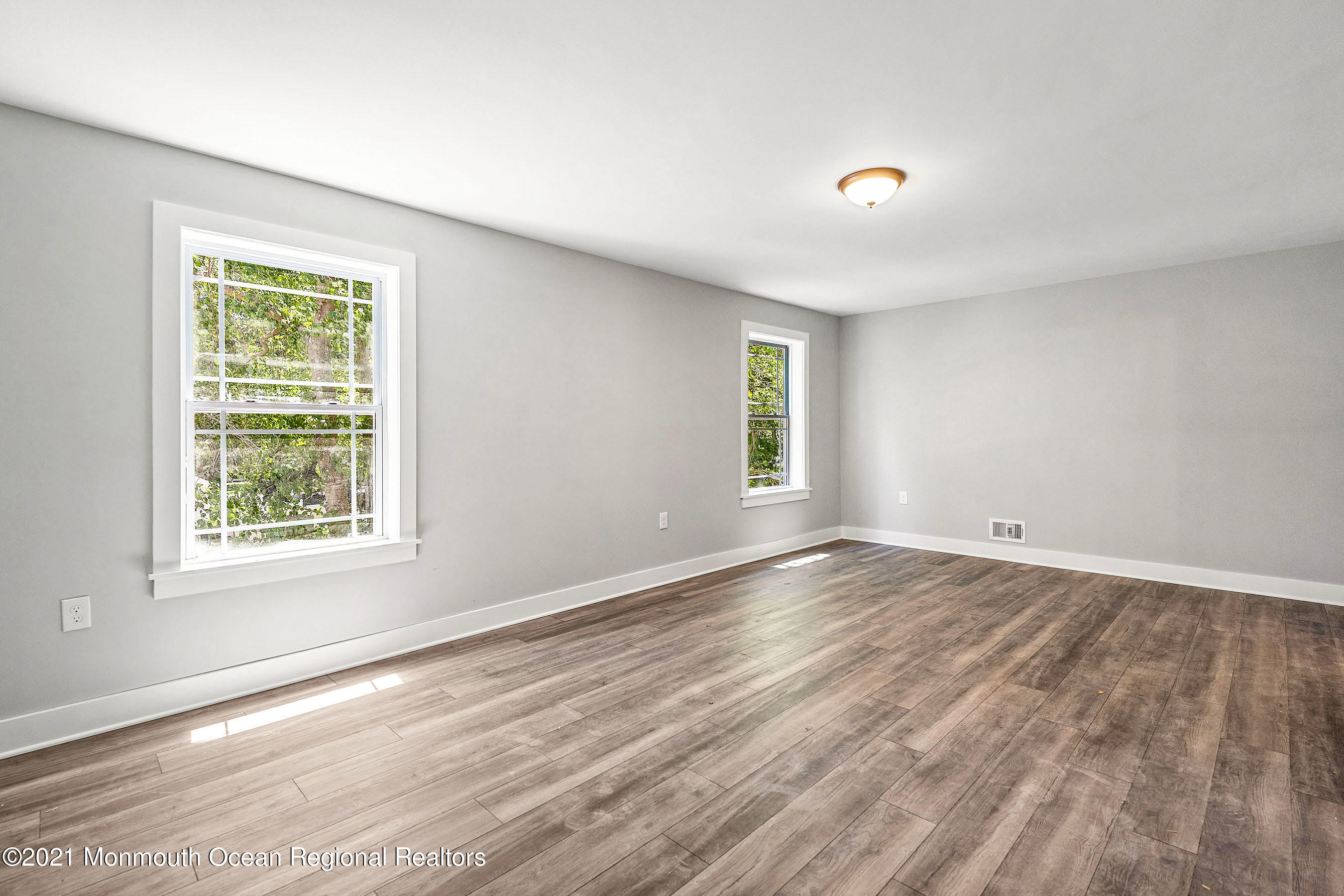 308 Riverside Drive Bayville, NJ 08721 - Photo 24 of 35 a view of an empty room with wooden floor and a window