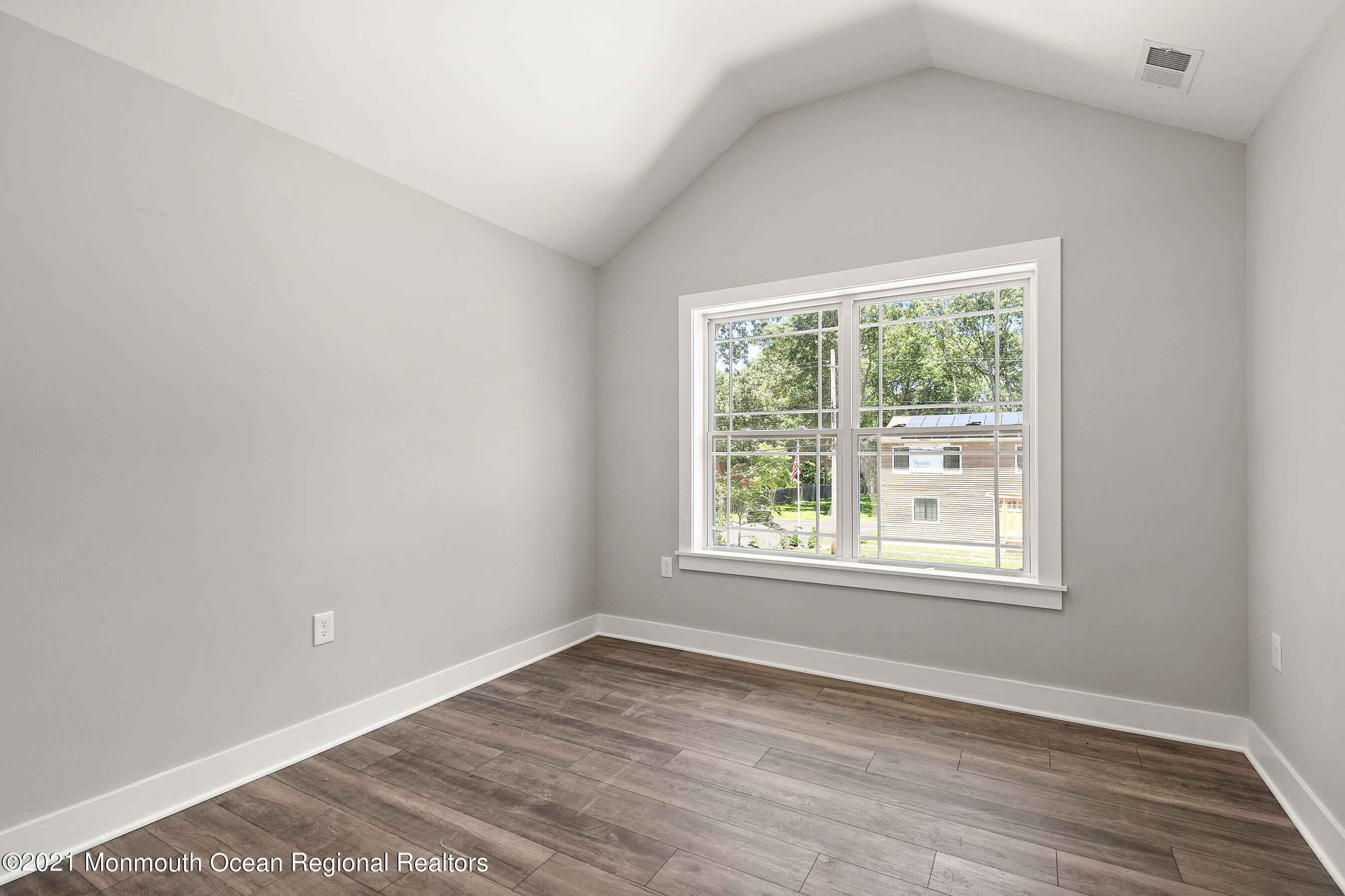 308 Riverside Drive Bayville, NJ 08721 - Photo 28 of 35 an empty room with wooden floor and windows