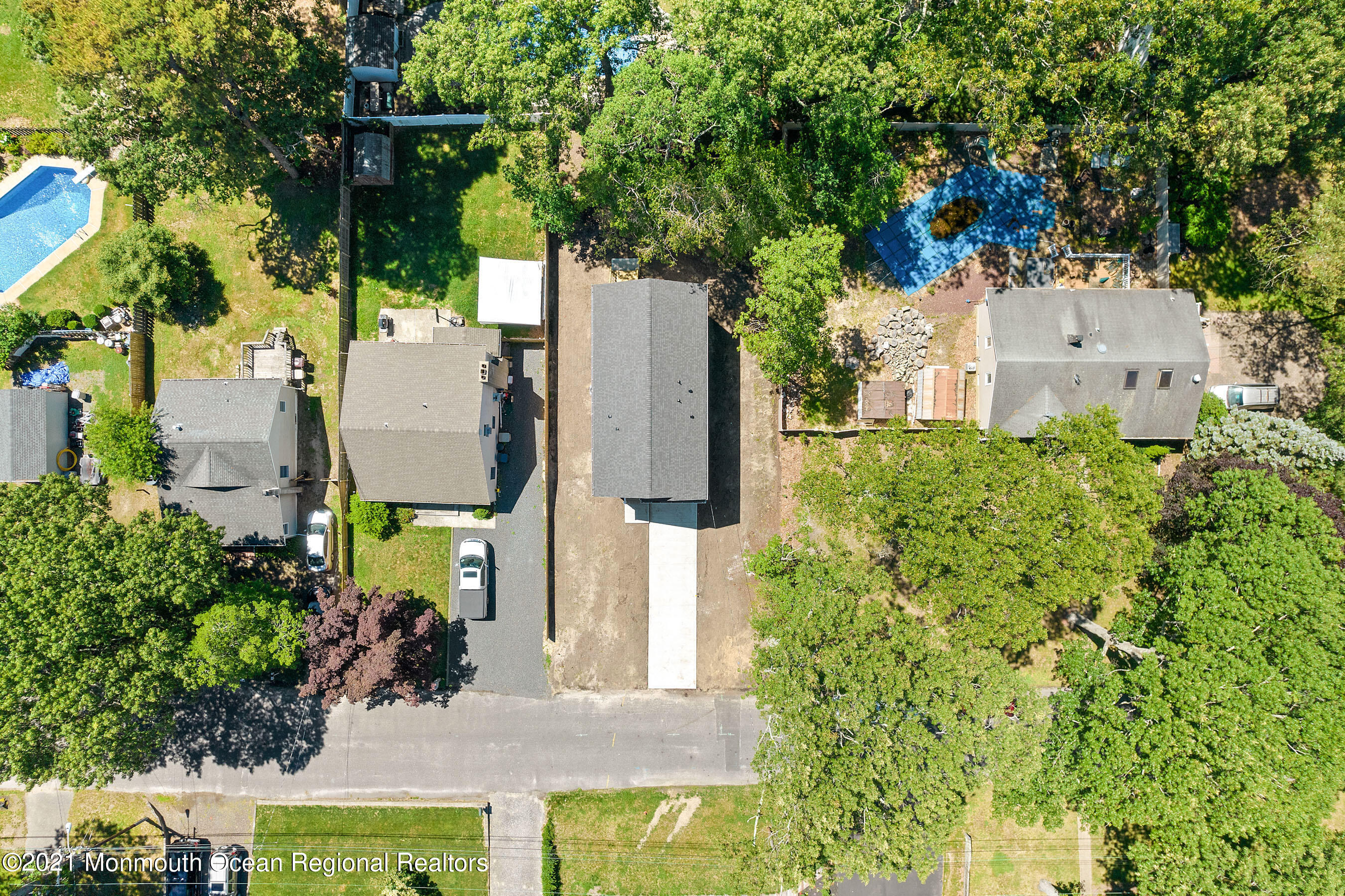 308 Riverside Drive Bayville, NJ 08721 - Photo 8 of 35 an aerial view of a house with a yard and large trees