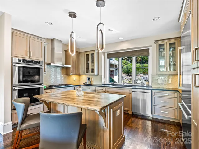 a kitchen with stainless steel appliances granite countertop a stove and a sink
