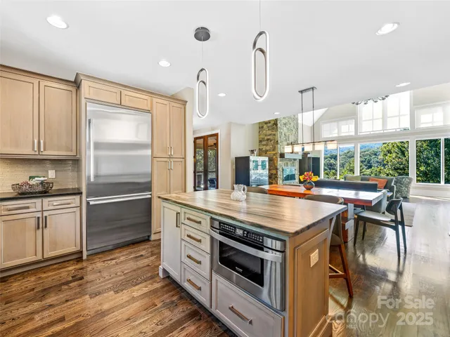 a kitchen with kitchen island a stove a sink and a refrigerator
