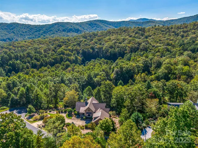 a view of a lush green hillside and a building