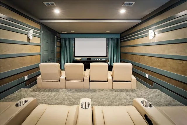 a bedroom with a large bed a flat tv screen and a ceiling fan