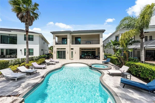 a living room with furniture a fireplace and a chandelier