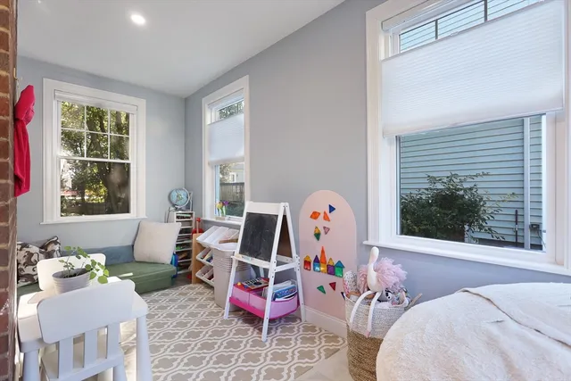 a bedroom with furniture and a large window