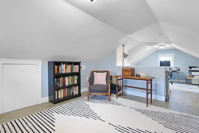 a bedroom with furniture and a book shelf