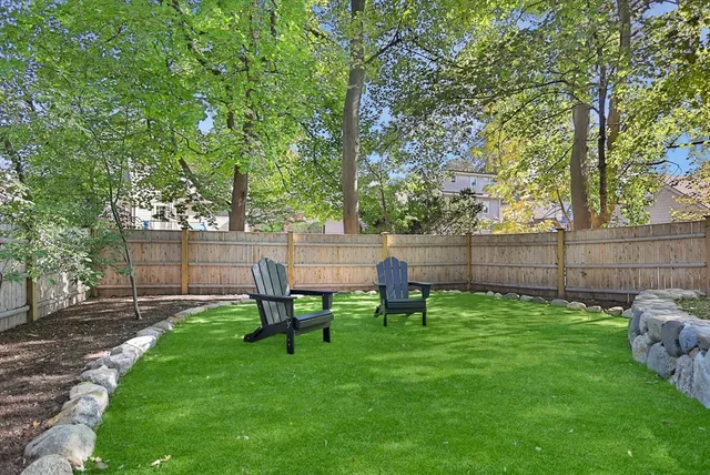 a view of a chair and table in the garden
