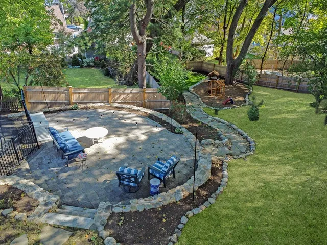 a view of a backyard with table and chairs
