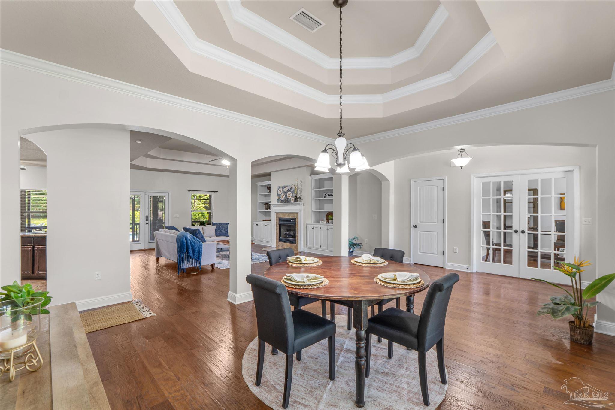 2698 Tulip Hill Road Pace, FL 32571 - Photo 4 of 65 a view of a dining room with furniture wooden floor and chandelier