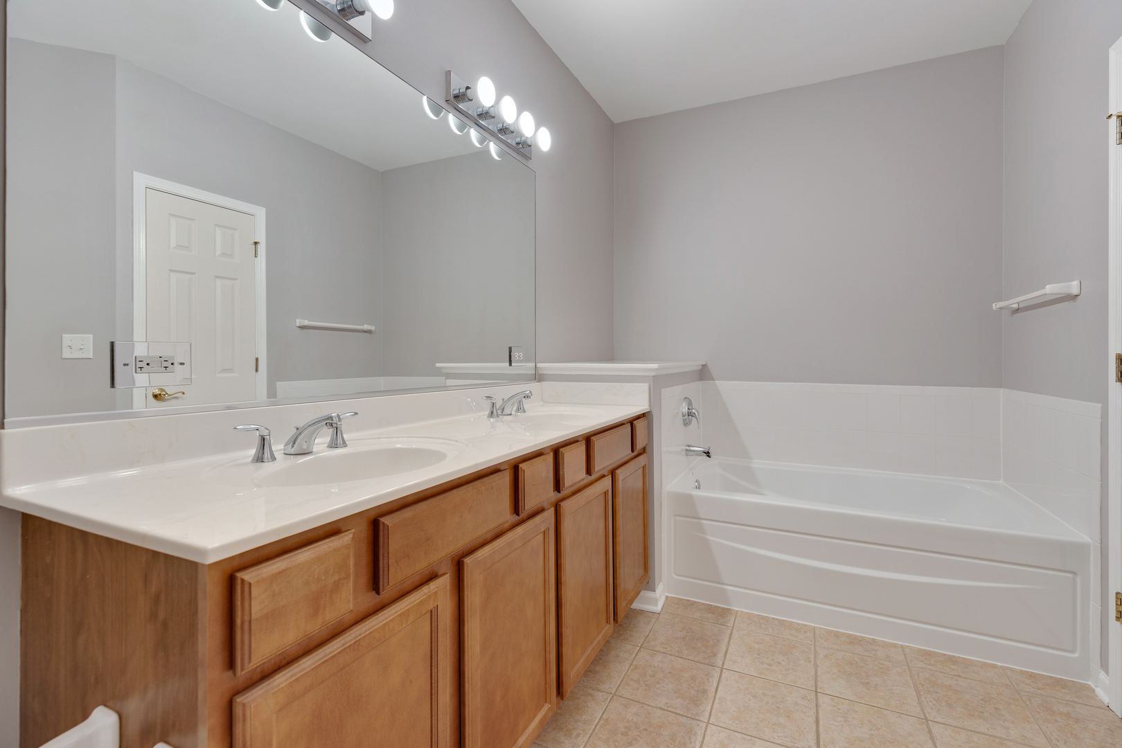 1382 Scarboro Road, Unit 1006 Schaumburg, IL 60193 - Photo 11 of 16 a bathroom with a sink double vanity and a bathtub