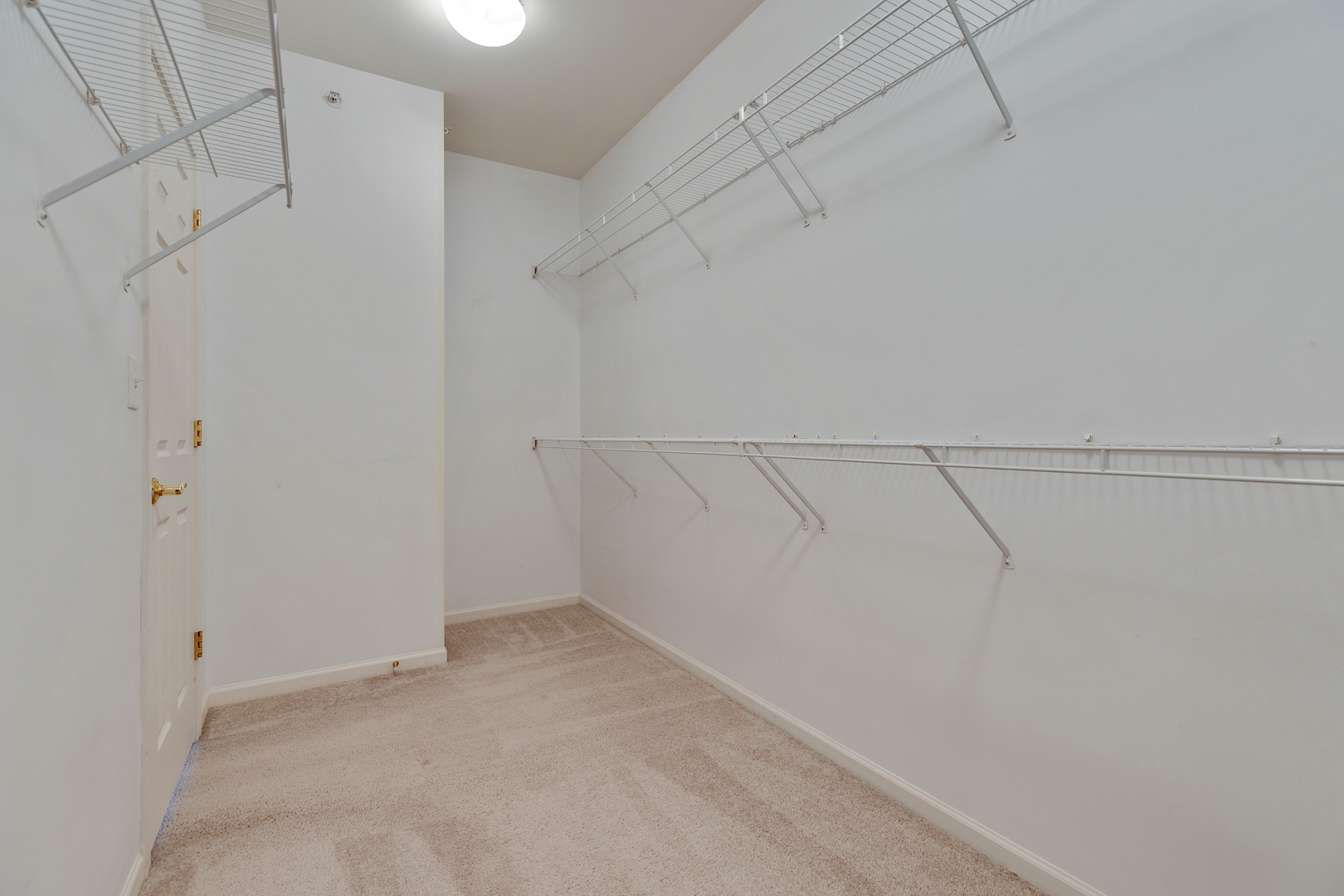 1382 Scarboro Road, Unit 1006 Schaumburg, IL 60193 - Photo 14 of 16 a view of a room with racks on the wall