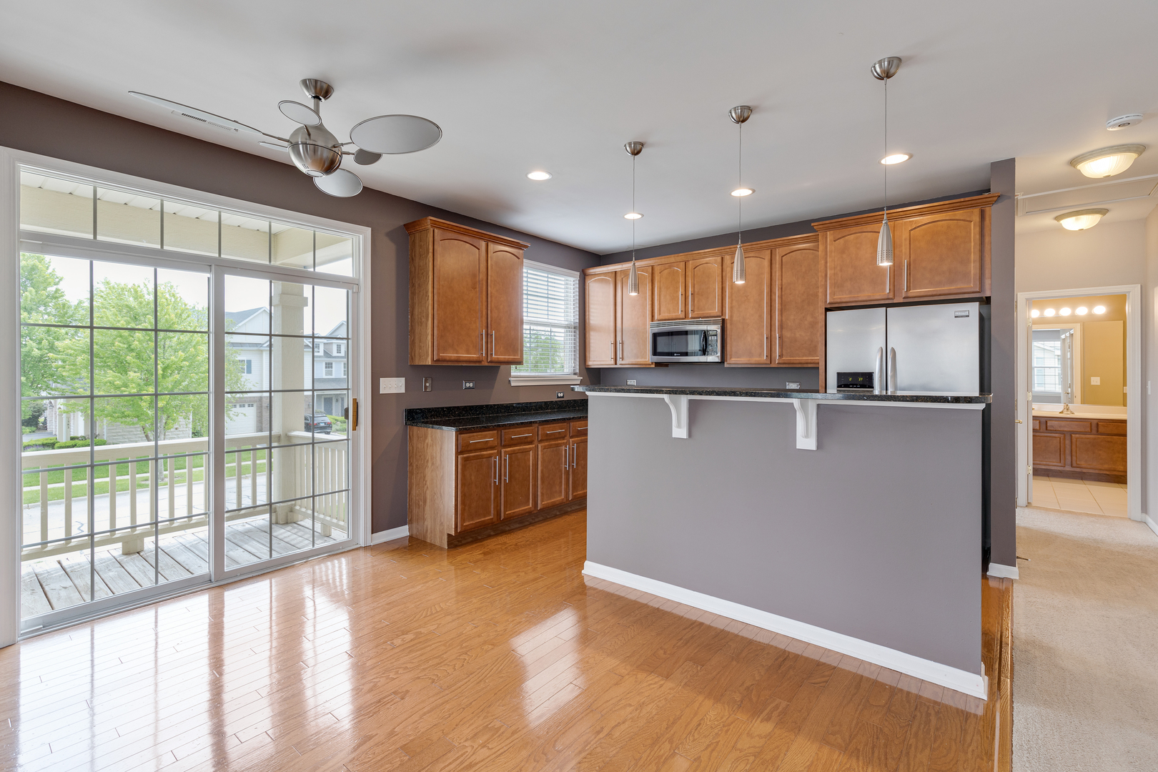 1382 Scarboro Road, Unit 1006 Schaumburg, IL 60193 - Photo 2 of 16 a kitchen with stainless steel appliances granite countertop a refrigerator a sink dishwasher a stove and white cabinets with wooden floor