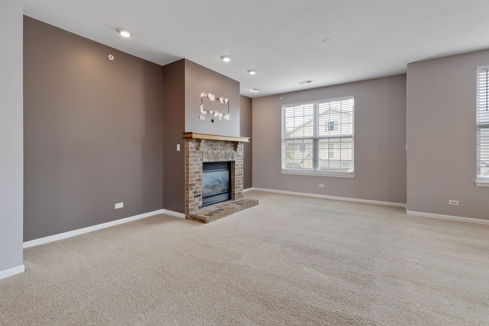 1382 Scarboro Road, Unit 1006 Schaumburg, IL 60193 - Photo 7 of 16 an empty room with windows and fireplace