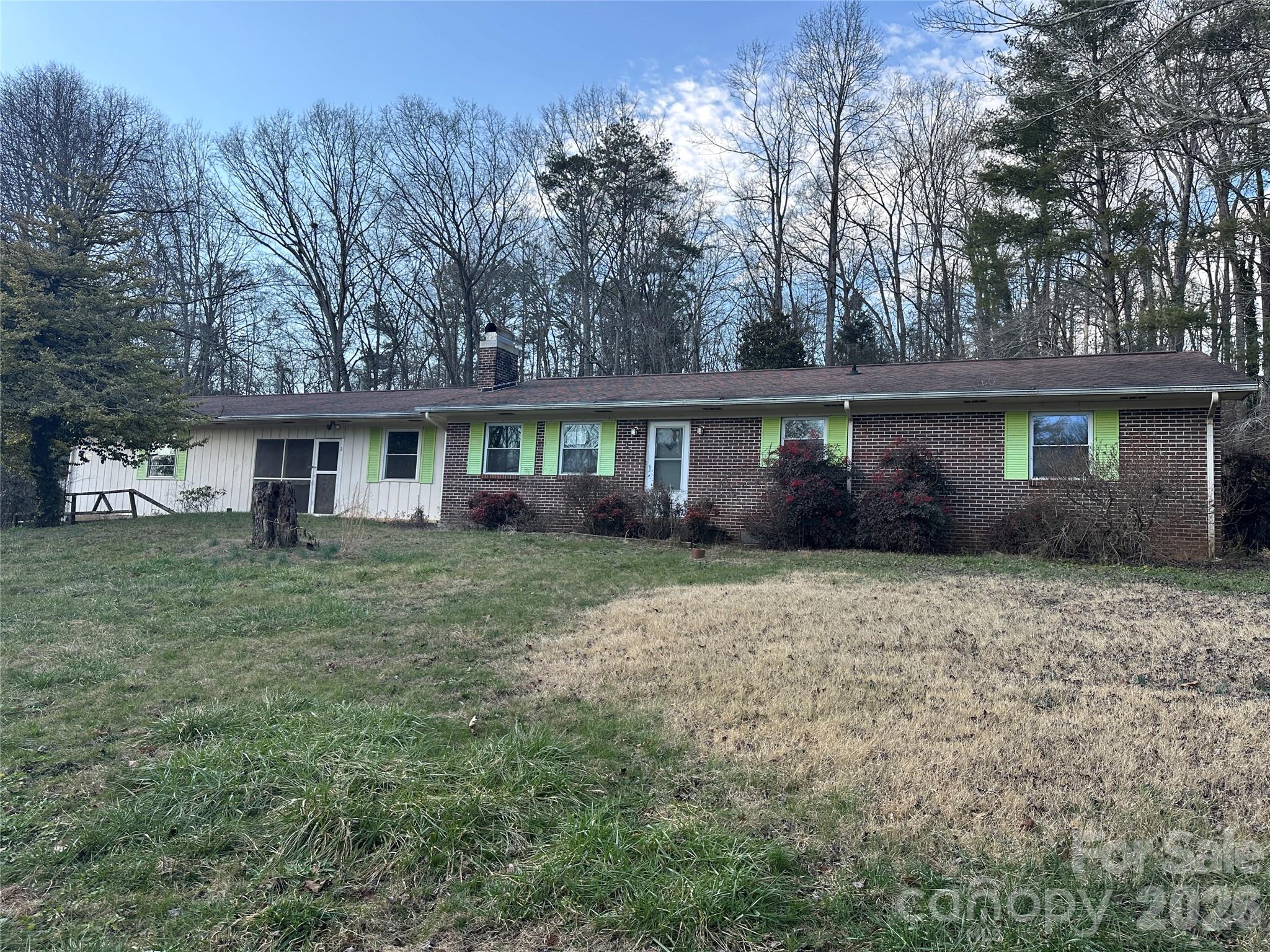 129 Ridgecrest Avenue Marble, NC 28905 - Photo 1 of 24 a front view of a house with a garden