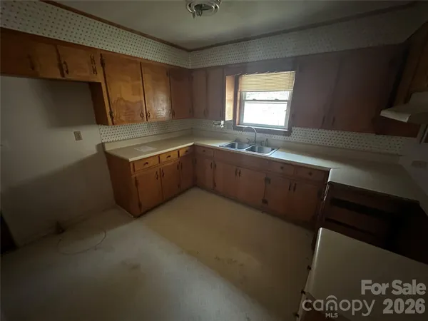 a kitchen with sink cabinets and window