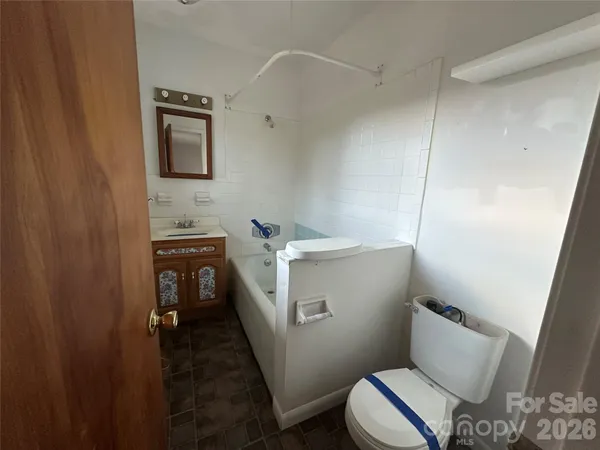 a bathroom with a sink a toilet and a mirror