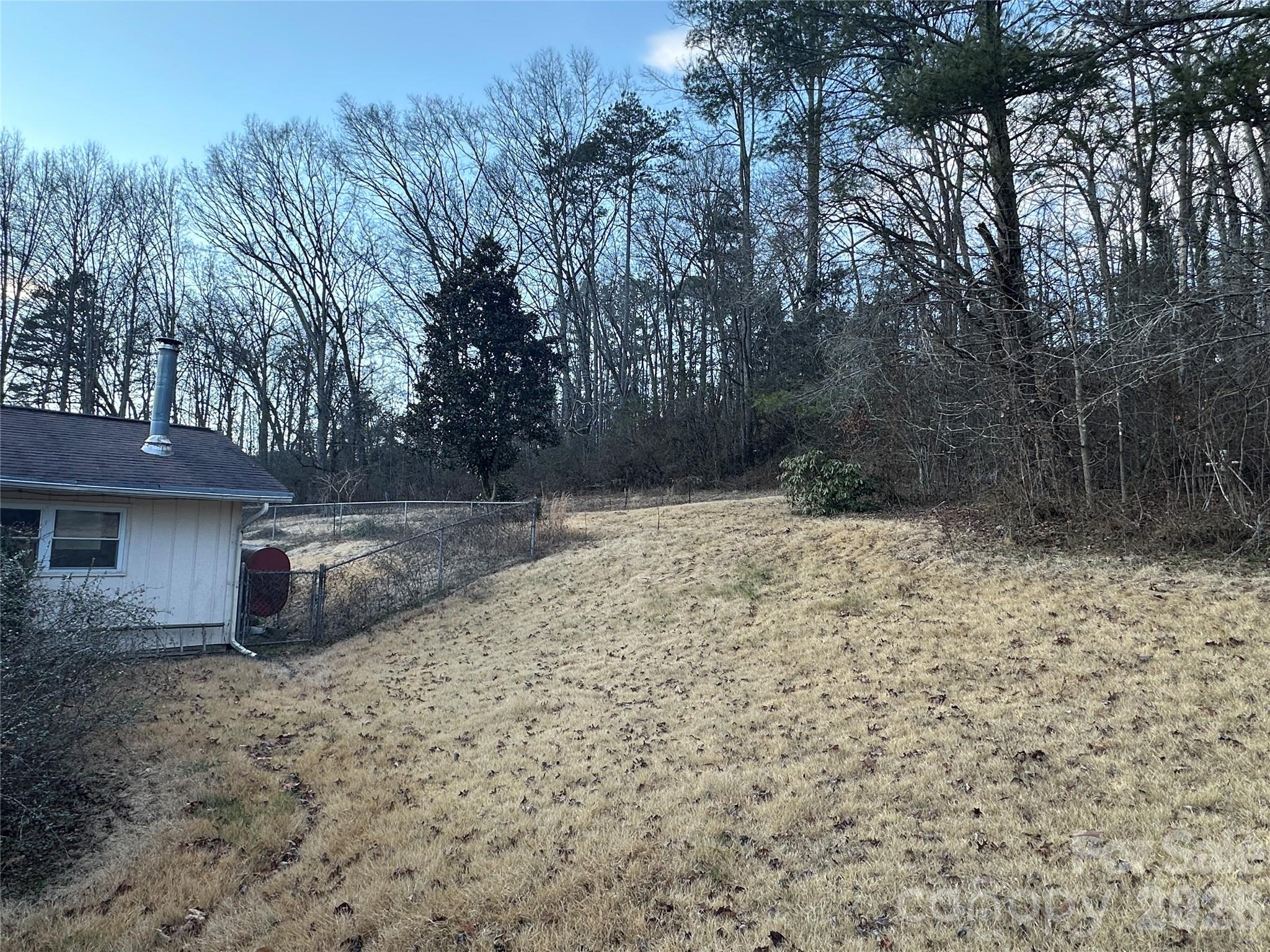 129 Ridgecrest Avenue Marble, NC 28905 - Photo 3 of 24 a backyard of a house with lots of green space