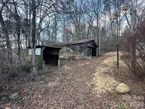 a view of a wooden house with a yard