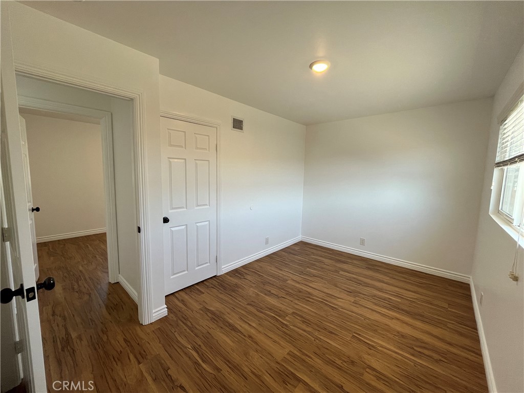 2476 Pierce Court Simi Valley, CA 93065 - Photo 13 of 18 an empty room with wooden floor and windows