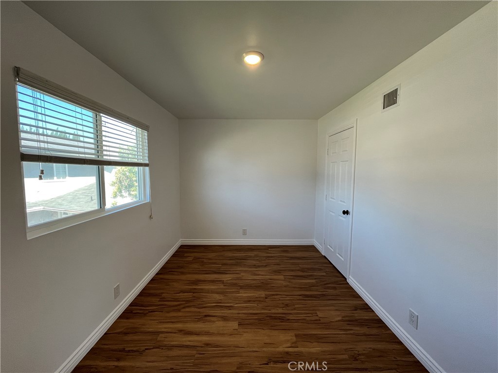 2476 Pierce Court Simi Valley, CA 93065 - Photo 14 of 18 a view of an empty room with wooden floor and a window