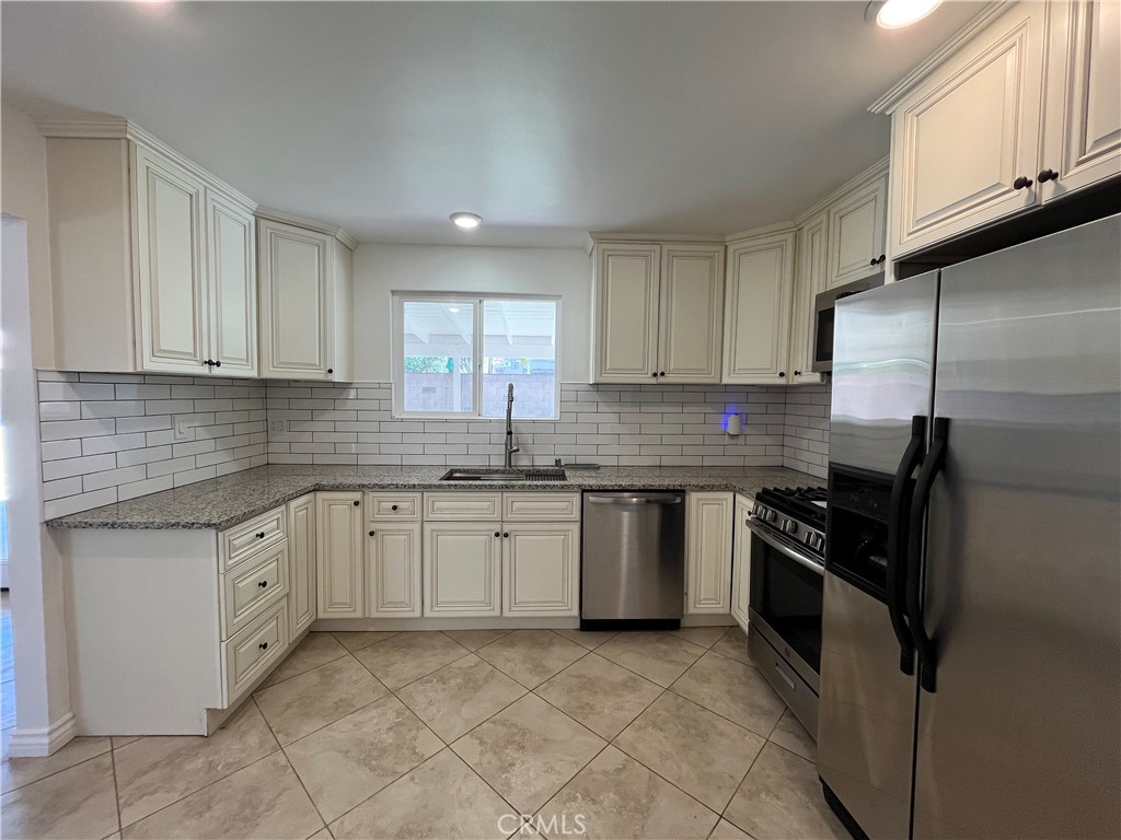 2476 Pierce Court Simi Valley, CA 93065 - Photo 2 of 18 a kitchen with granite countertop cabinets stainless steel appliances and a sink