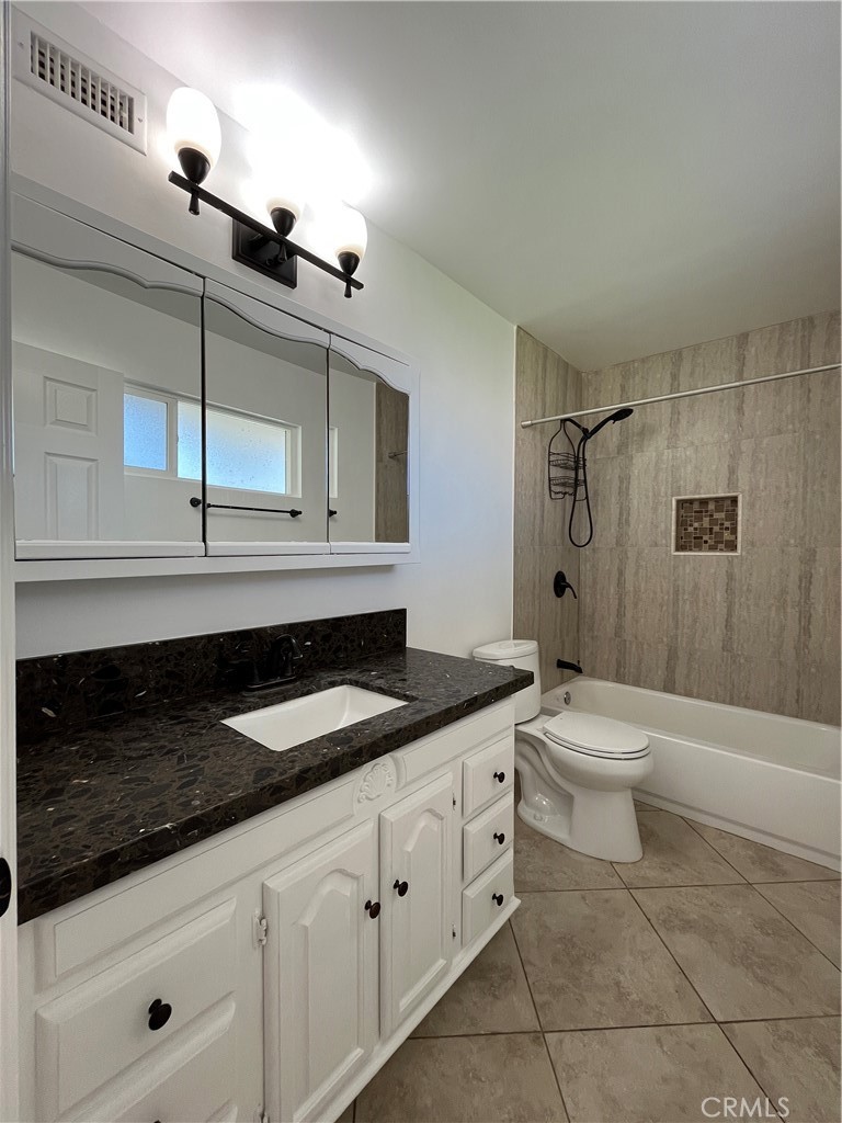 2476 Pierce Court Simi Valley, CA 93065 - Photo 7 of 18 a bathroom with a granite countertop sink a toilet a mirror and shower