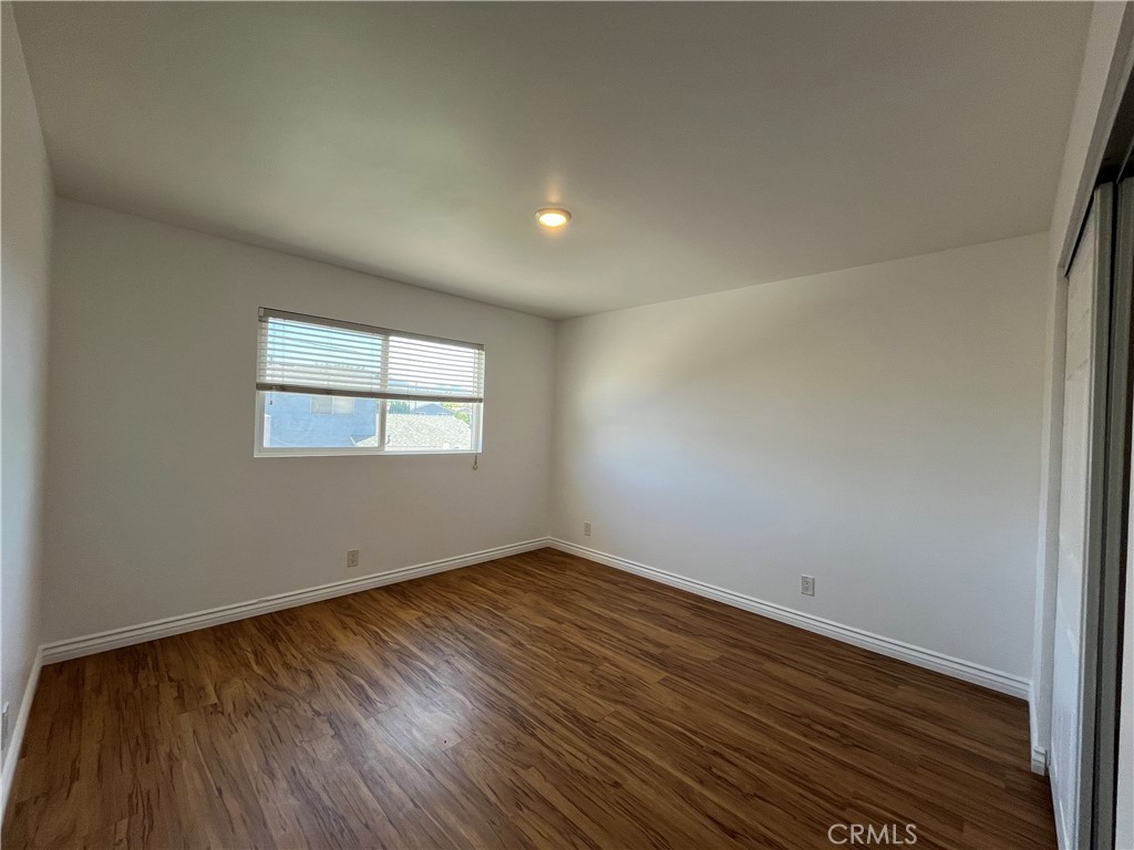 2476 Pierce Court Simi Valley, CA 93065 - Photo 9 of 18 a view of an empty room with wooden floor and a window