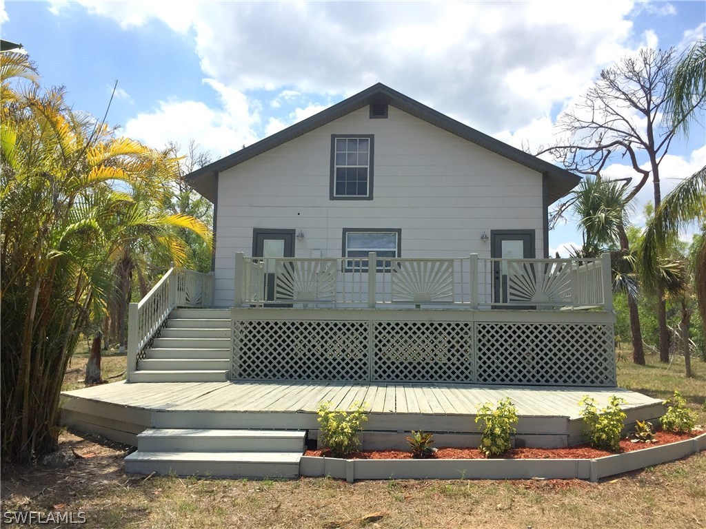 20291 Carter Road Estero, FL 33928 - Photo 1 of 25 a front view of a house with a yard