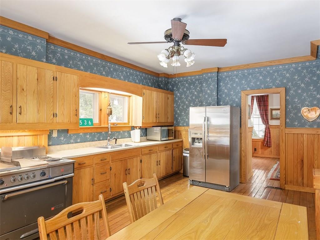 2536 County Line Road Champion, PA 15622 - Photo 6 of 25 Here's the huge eat in kitchen with powder room just off to the left. Oak cabinets and commercial electric stove!