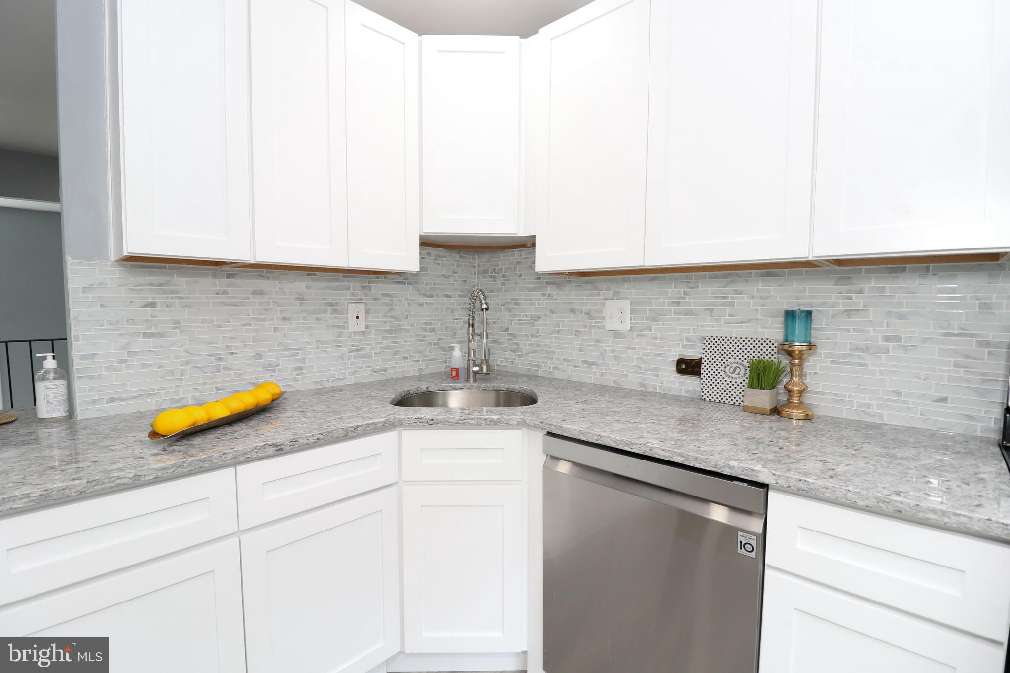 2309 Ravensdon Court Reston, VA 20191 - Photo 13 of 76 a kitchen with a sink a counter and cabinets