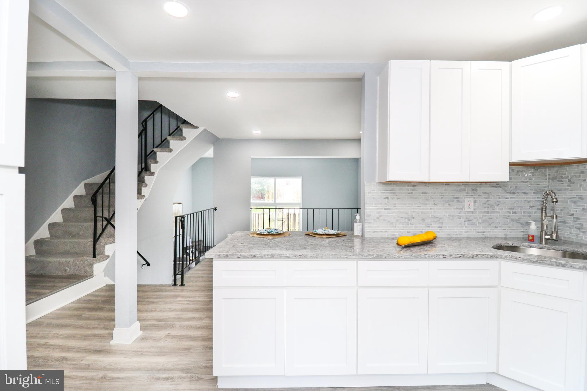 2309 Ravensdon Court Reston, VA 20191 - Photo 18 of 76 a kitchen with a sink a counter space and cabinets