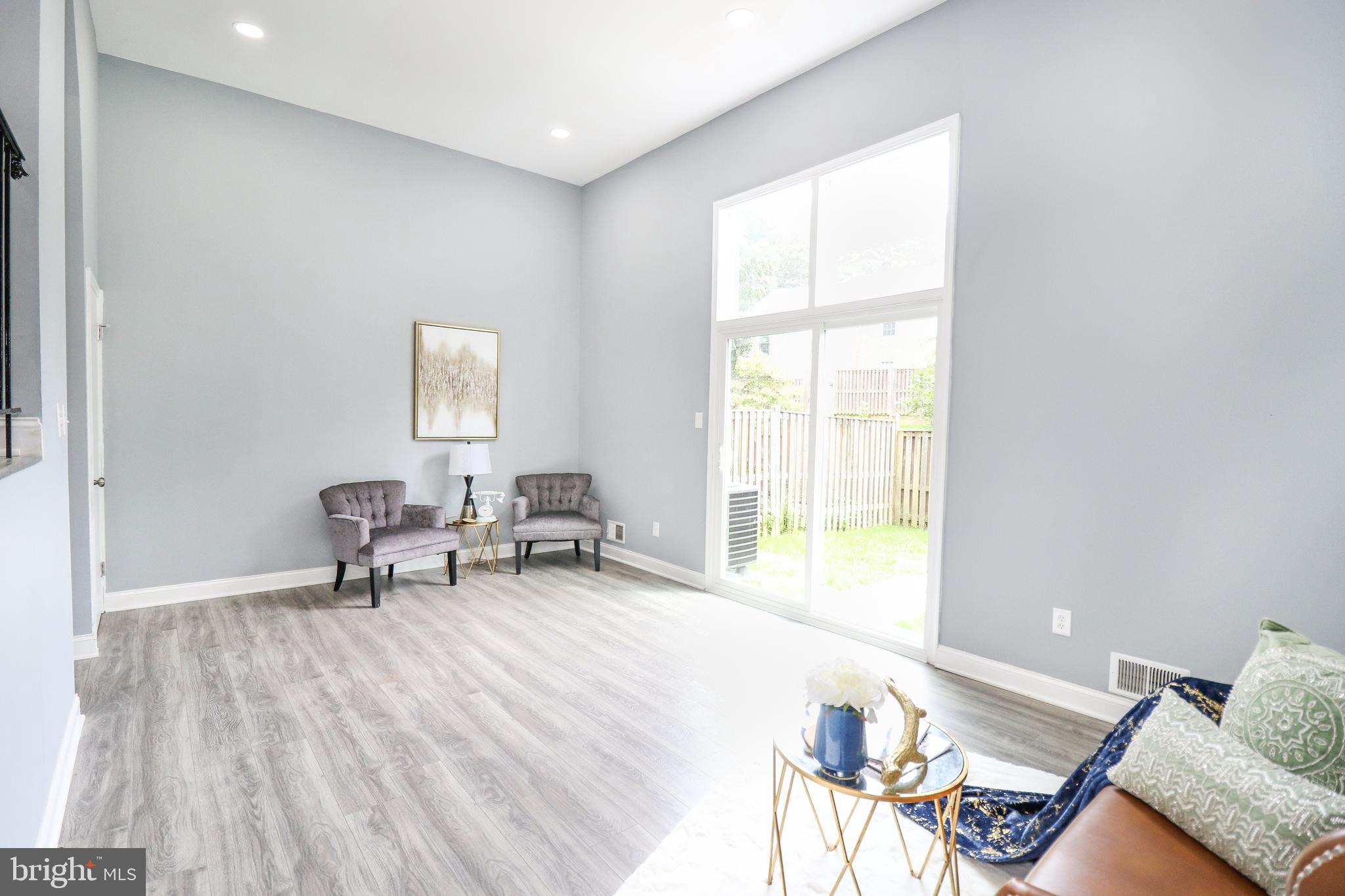 2309 Ravensdon Court Reston, VA 20191 - Photo 29 of 76 a living room with furniture and two window
