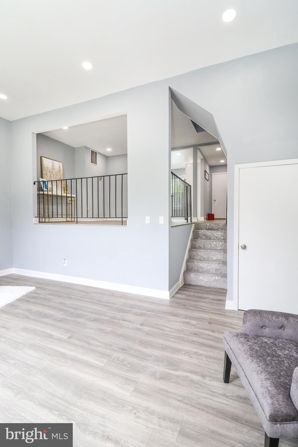 2309 Ravensdon Court Reston, VA 20191 - Photo 31 of 76 a view of a hallway with wooden floor and a living room
