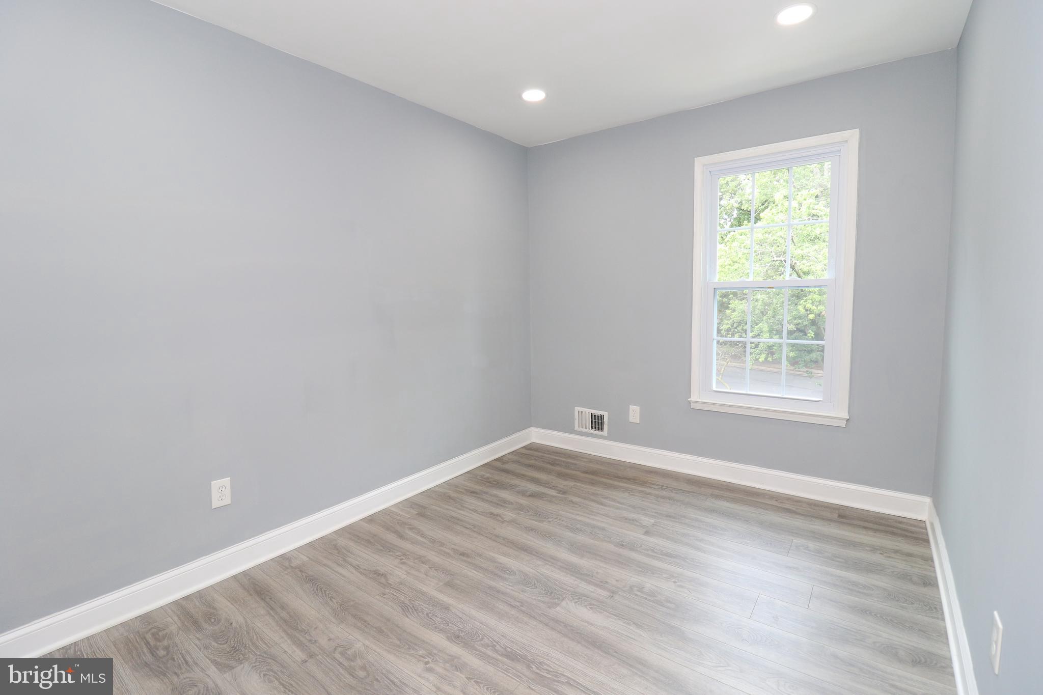 2309 Ravensdon Court Reston, VA 20191 - Photo 46 of 76 a view of an empty room with wooden floor and a window