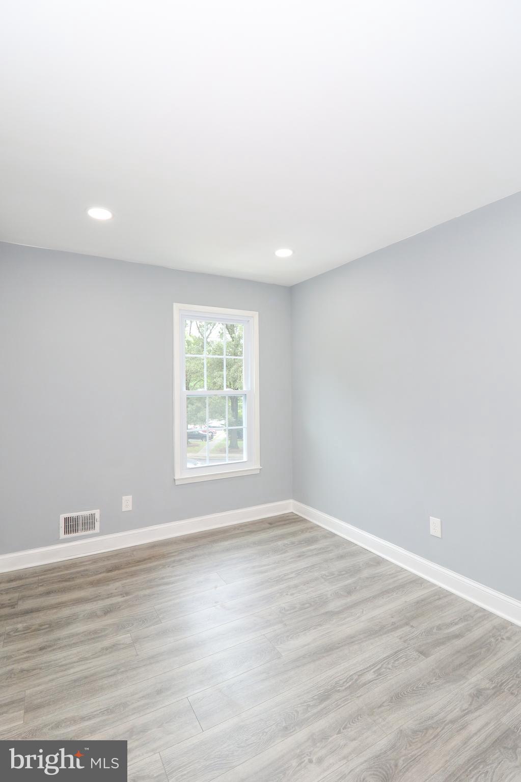 2309 Ravensdon Court Reston, VA 20191 - Photo 49 of 76 a view of an empty room with wooden floor and a window