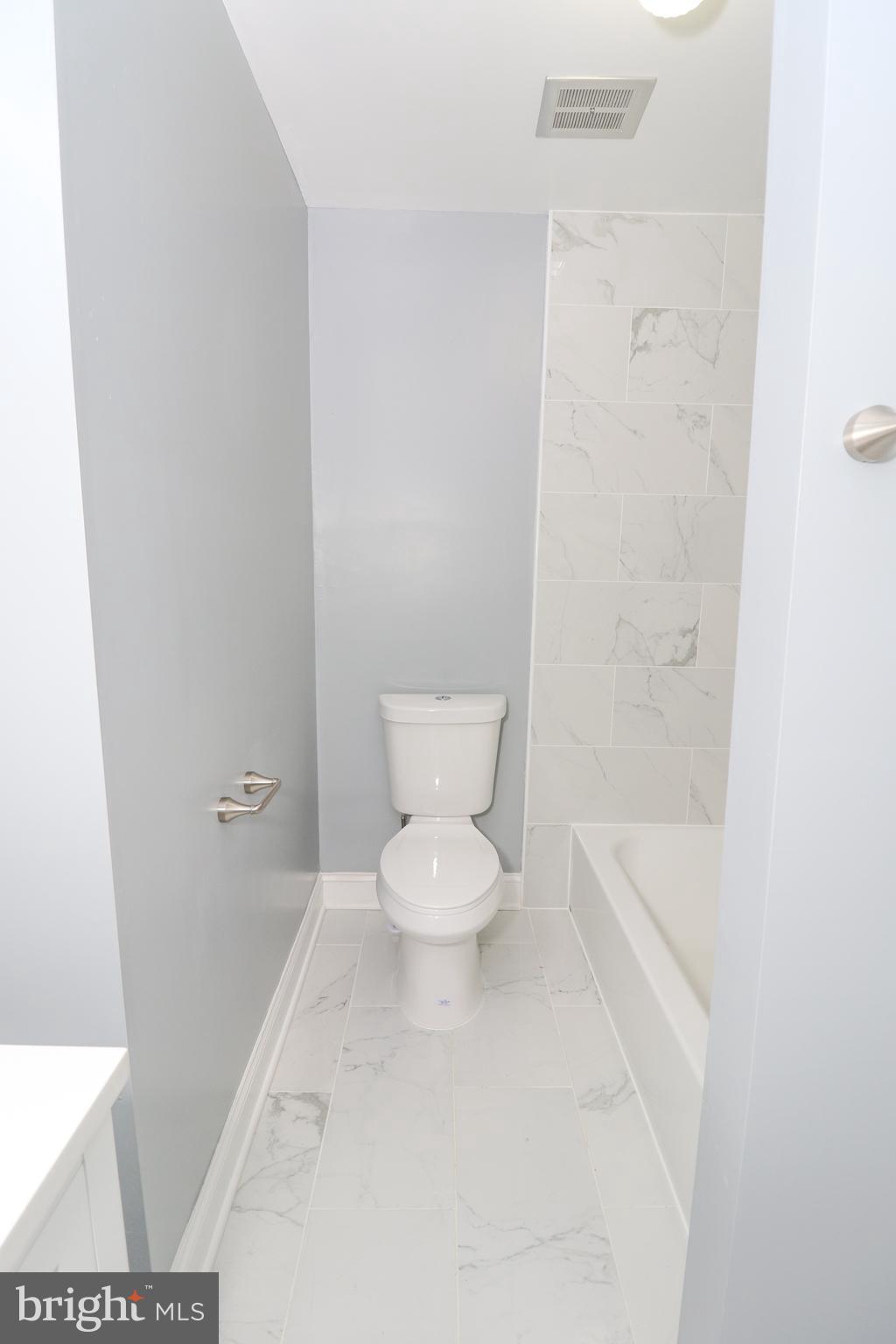 2309 Ravensdon Court Reston, VA 20191 - Photo 53 of 76 a white toilet sitting next to a bathroom sink