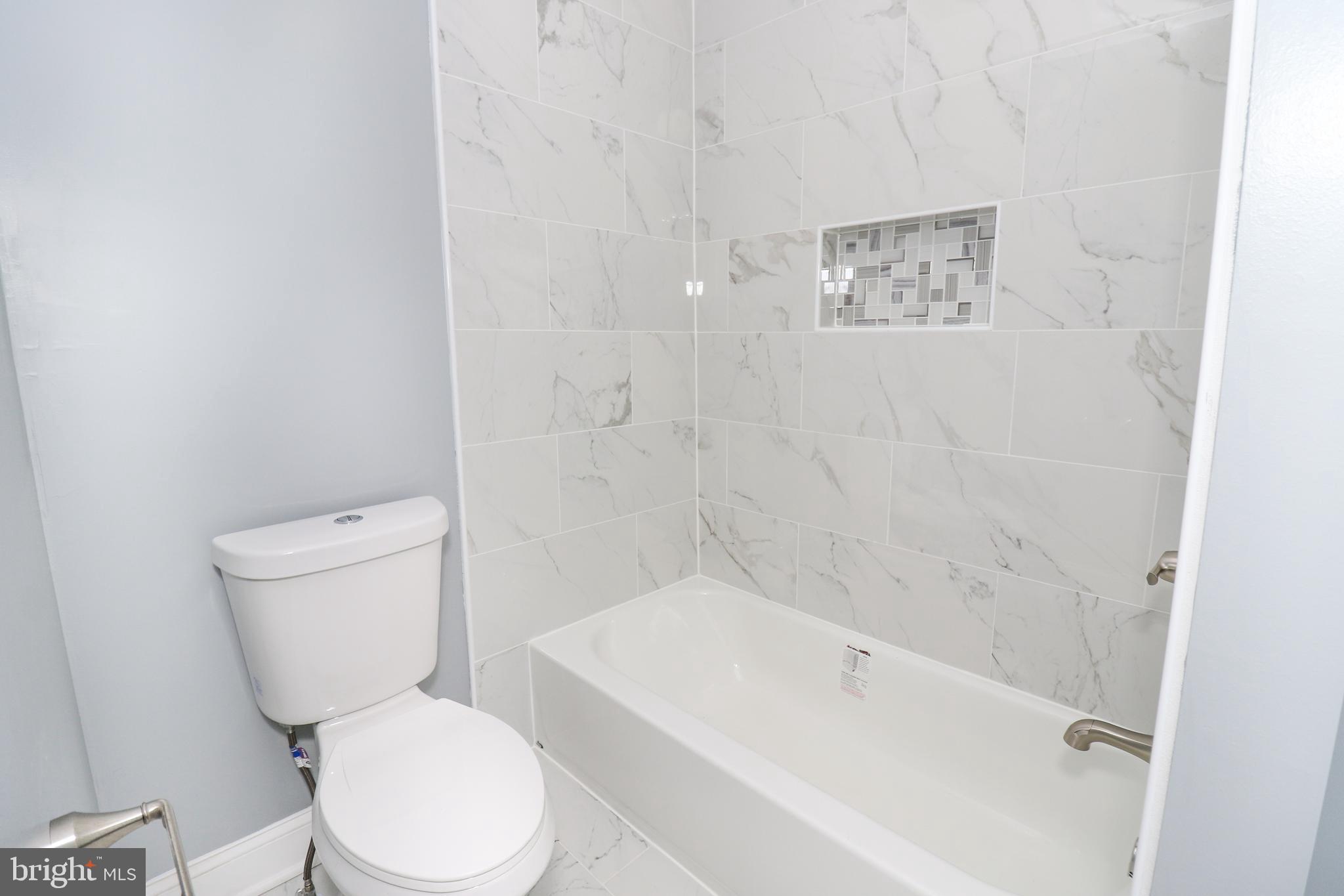 2309 Ravensdon Court Reston, VA 20191 - Photo 56 of 76 a white toilet sitting next to a bath tub