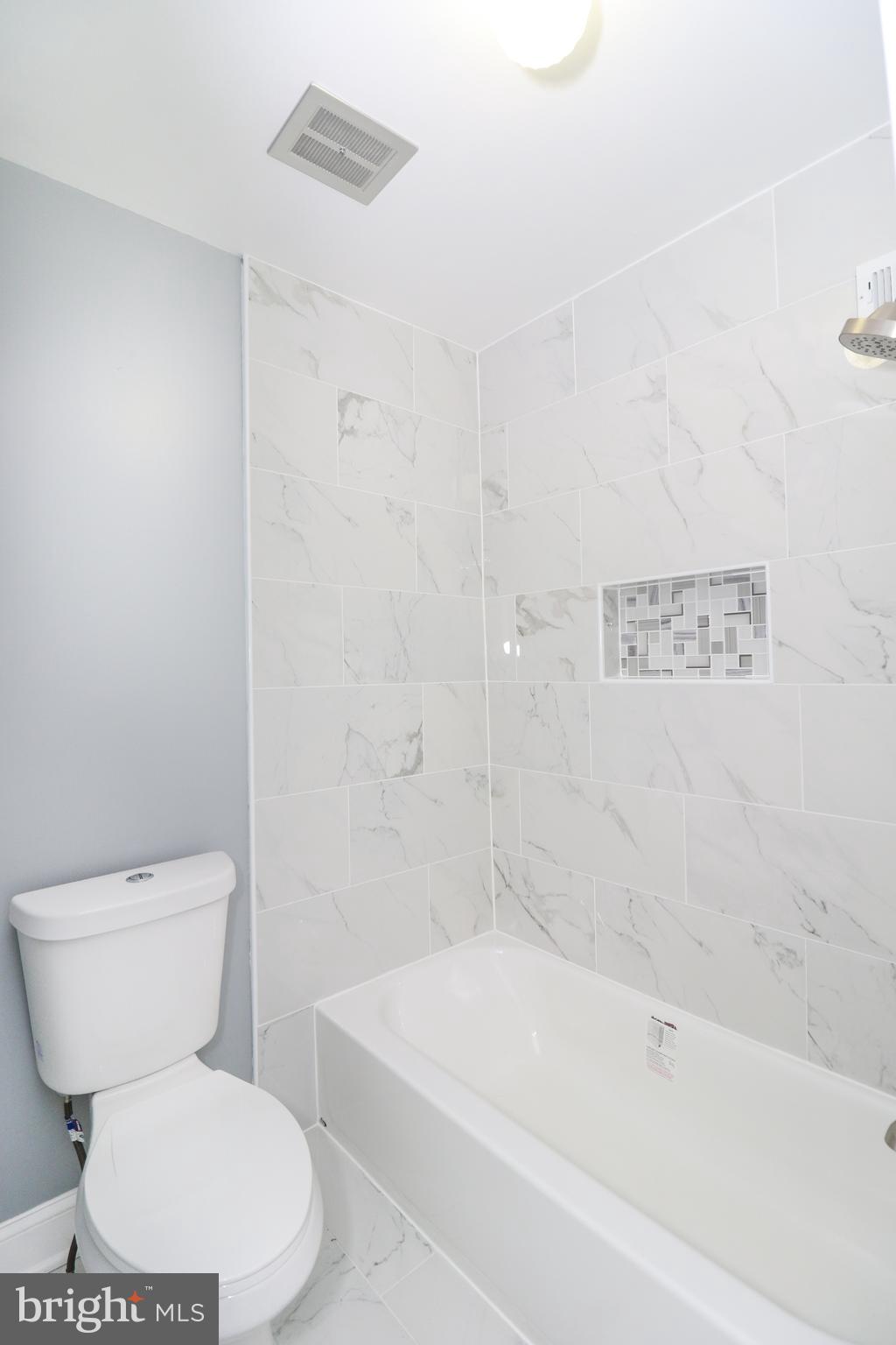 2309 Ravensdon Court Reston, VA 20191 - Photo 57 of 76 a white toilet sitting next to a bath tub