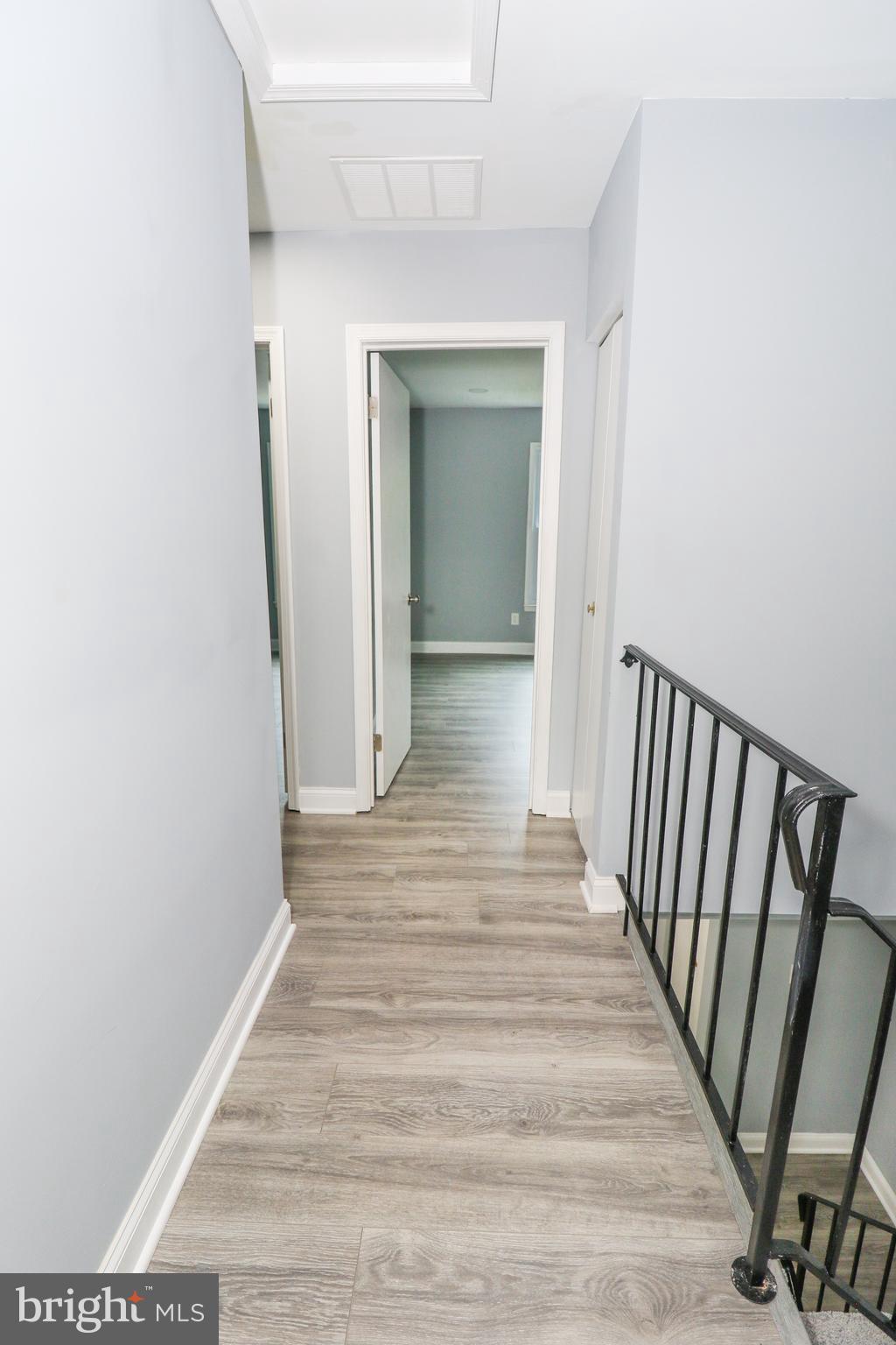 2309 Ravensdon Court Reston, VA 20191 - Photo 58 of 76 a view of a hallway with wooden floor and staircase