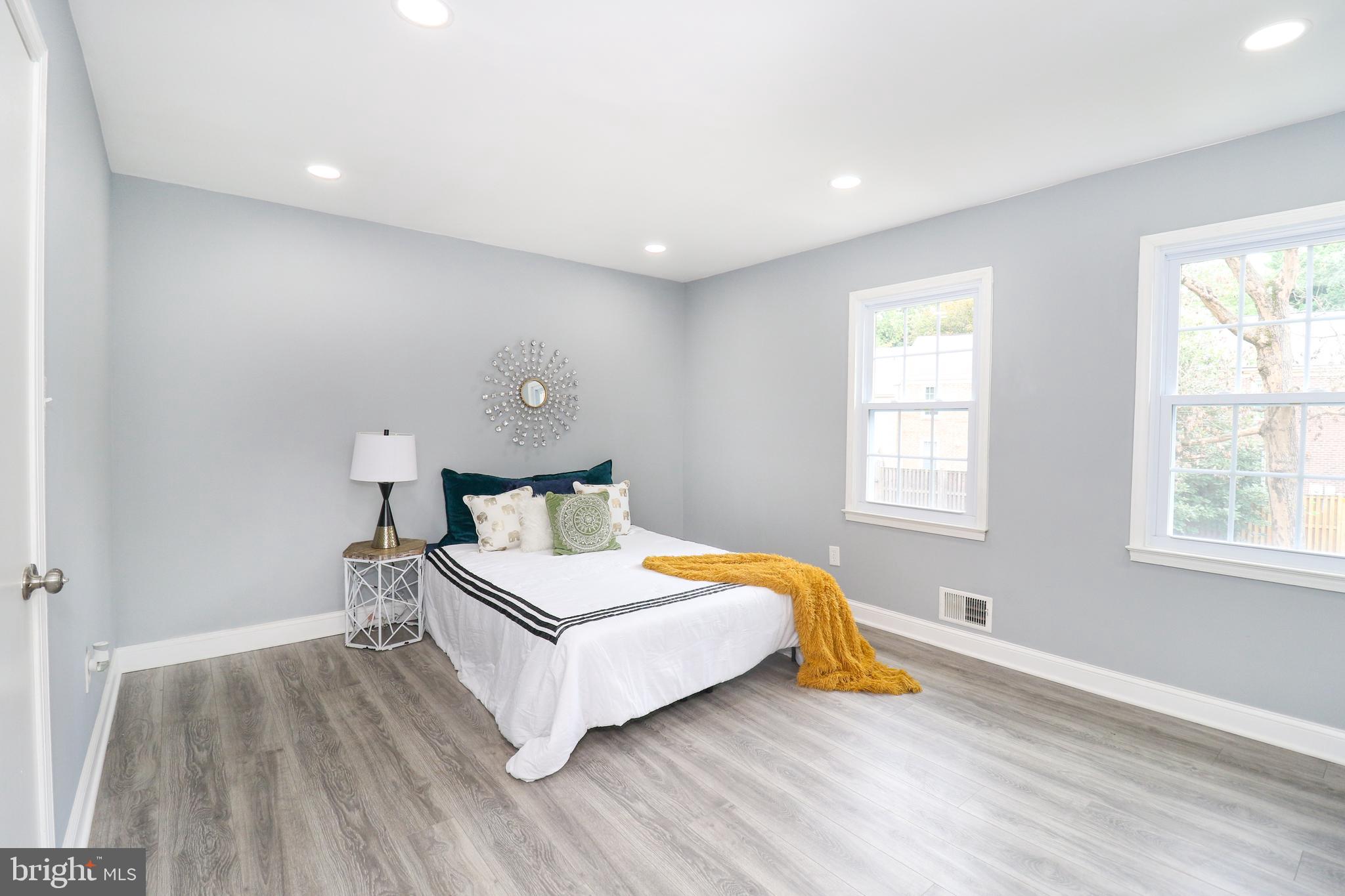 2309 Ravensdon Court Reston, VA 20191 - Photo 60 of 76 a bedroom with a bed and wooden floor