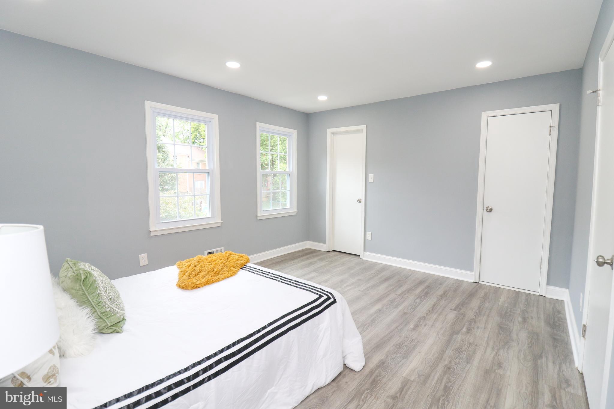 2309 Ravensdon Court Reston, VA 20191 - Photo 61 of 76 a bedroom with a bed and wooden floor