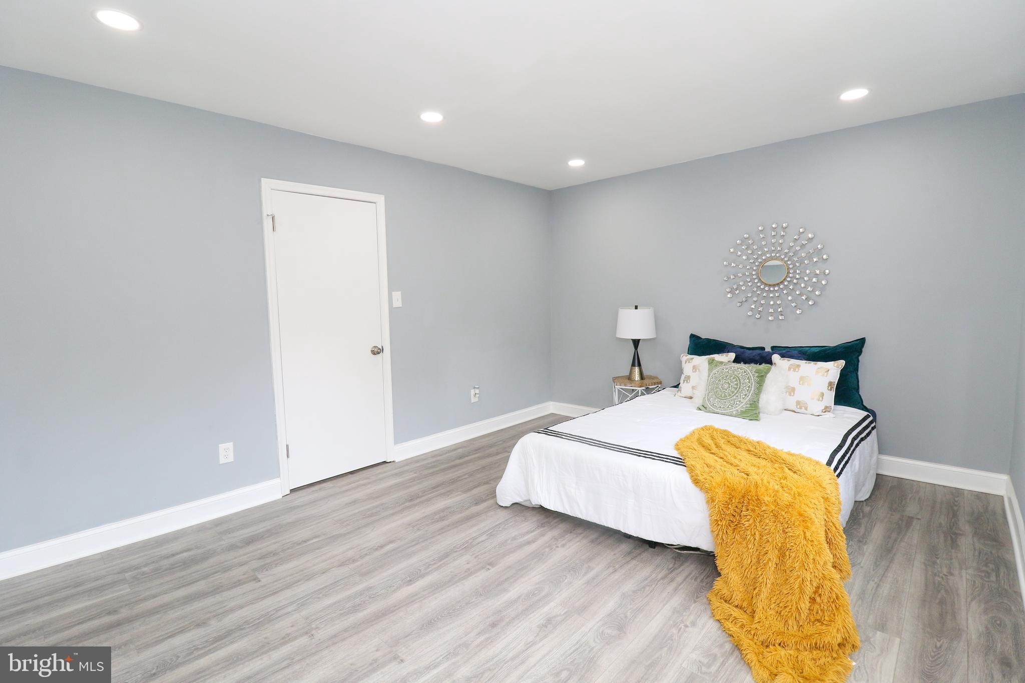 2309 Ravensdon Court Reston, VA 20191 - Photo 63 of 76 a bedroom with a bed and wooden floor